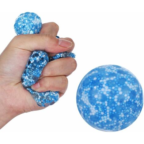Teen boy playing with anti stress sensory ball squeeze toy. Giant stress  balls are soft to