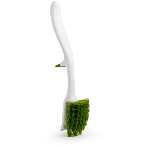 Brosse à vaisselle blanche avec support intégré pour le rangement sur le bord.