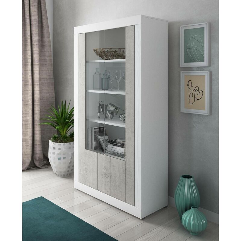 

Librería en color blanco y cemento, con dos puertas con vidrio y estantes internos desarrollados en altura, 105 x 42 x h191 cm - Dmora