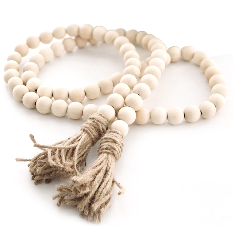Guirlande de perles en bois avec pompon jute