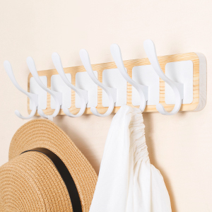 White coat rack behind the door for storing coats and hats