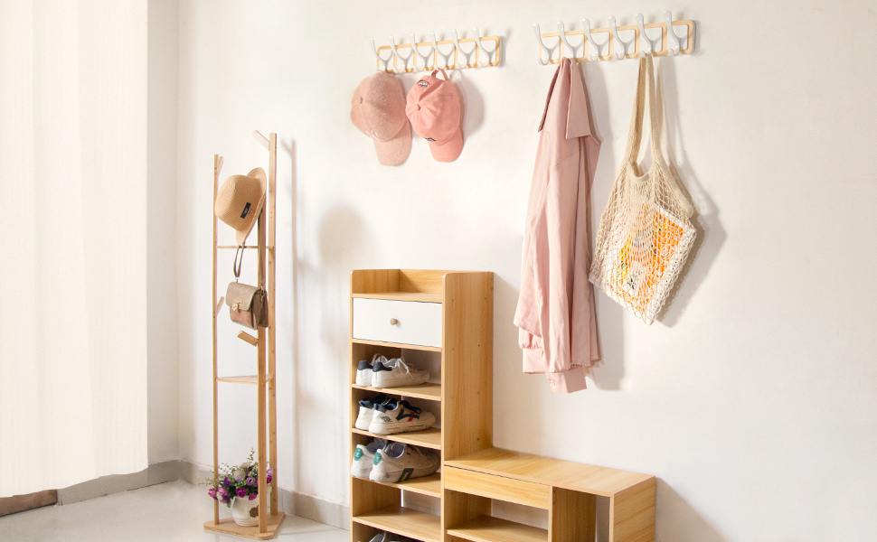 At the entrance,  2 wooden wall-mounted coat racks, natural shoe cabinets, standing coat racks