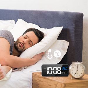 un homme qui dort sur un lit avec une horloge sur le côté