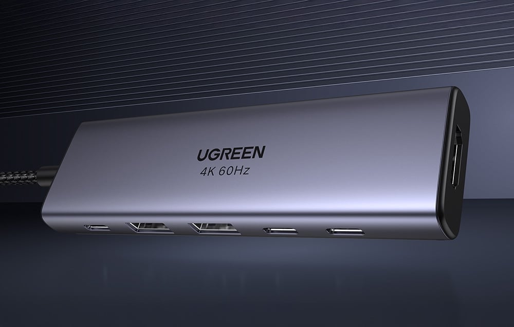 Hub in alluminio Ugreen 4K 60Hz con diverse porte USB-C, USB-A e HDMI, visibile lateralmente su uno sfondo scuro.