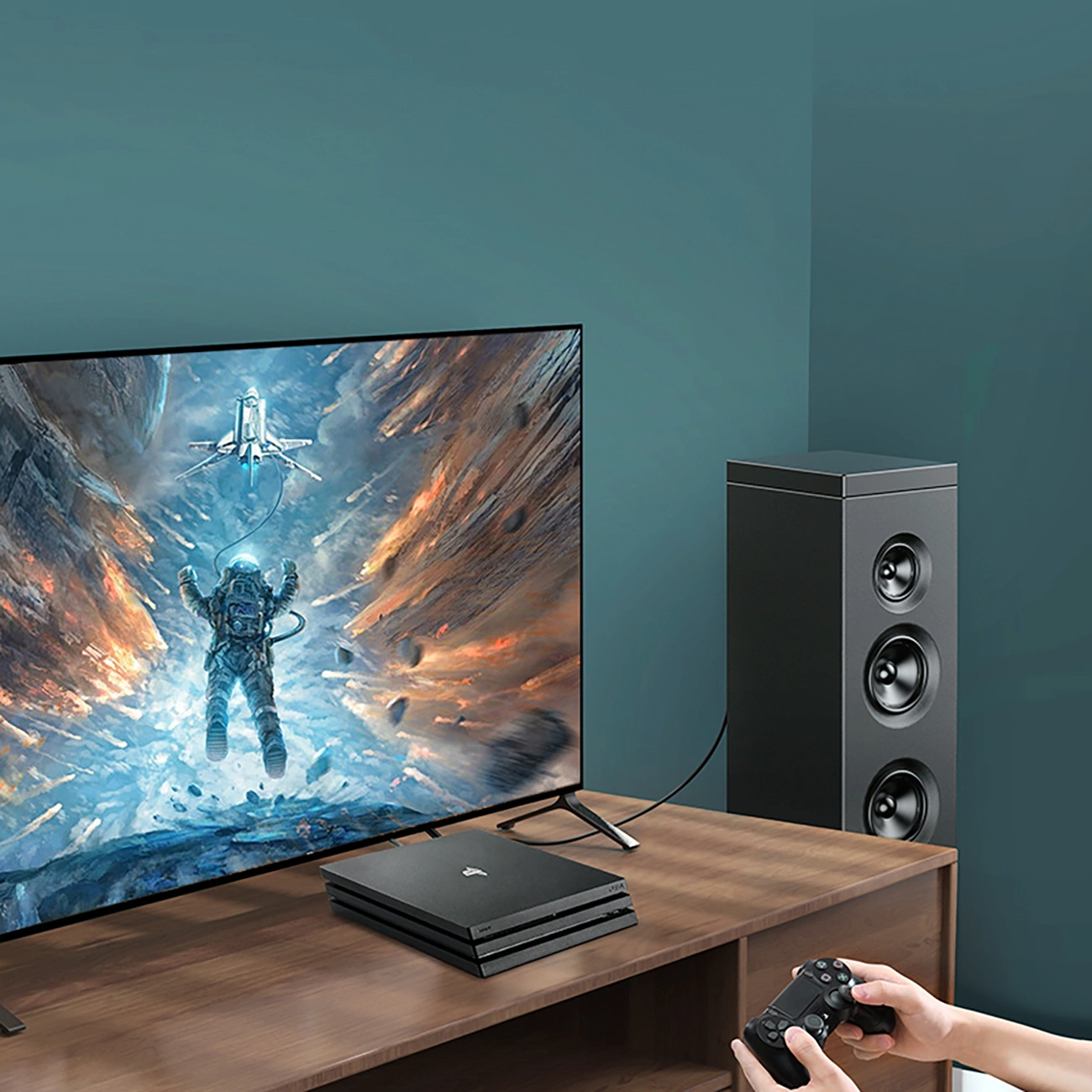 Una persona toca en una consola a la que está conectado el altavoz mediante el cable óptico Ugreen AV122