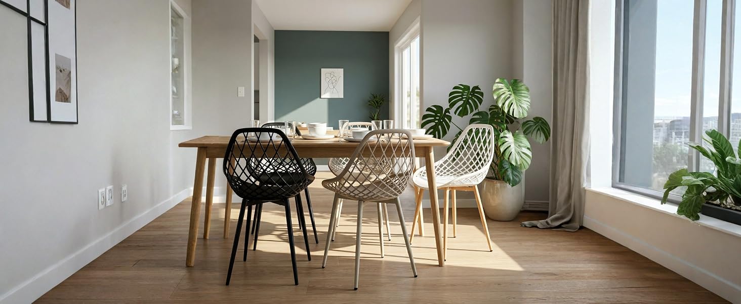 Modernes Esszimmer mit Holztisch, schwarzen und natürlichen Holzstühlen, Topfpflanzen, Holzböden und hellem Tageslicht durch die Fenster.