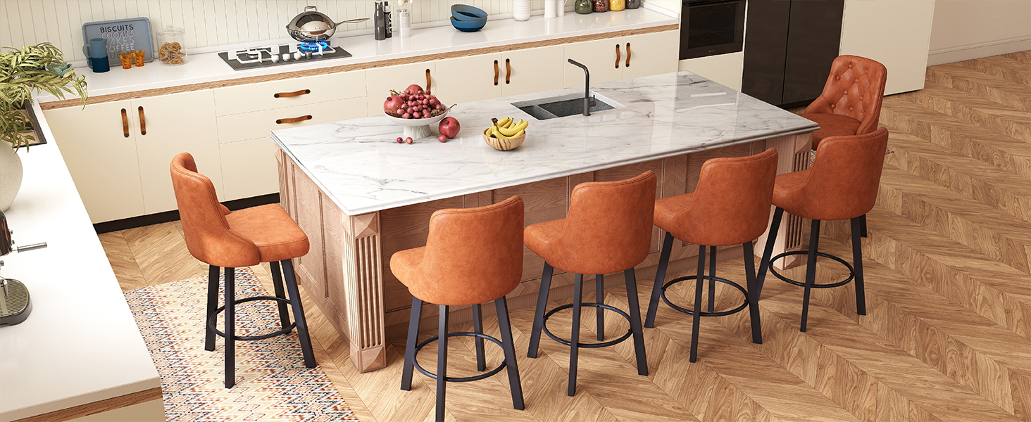 Modern kitchen island with white marble countertop and orange high-back bar stools. Clean, contemporary design with pendant lighting above.