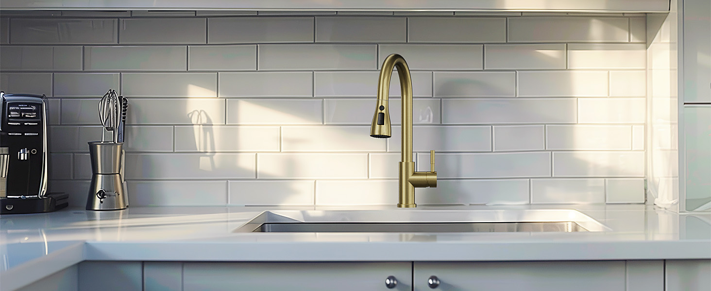 Modern kitchen featuring white subway tile backsplash, marble countertop, and brass pull-down faucet with clean minimalist design.