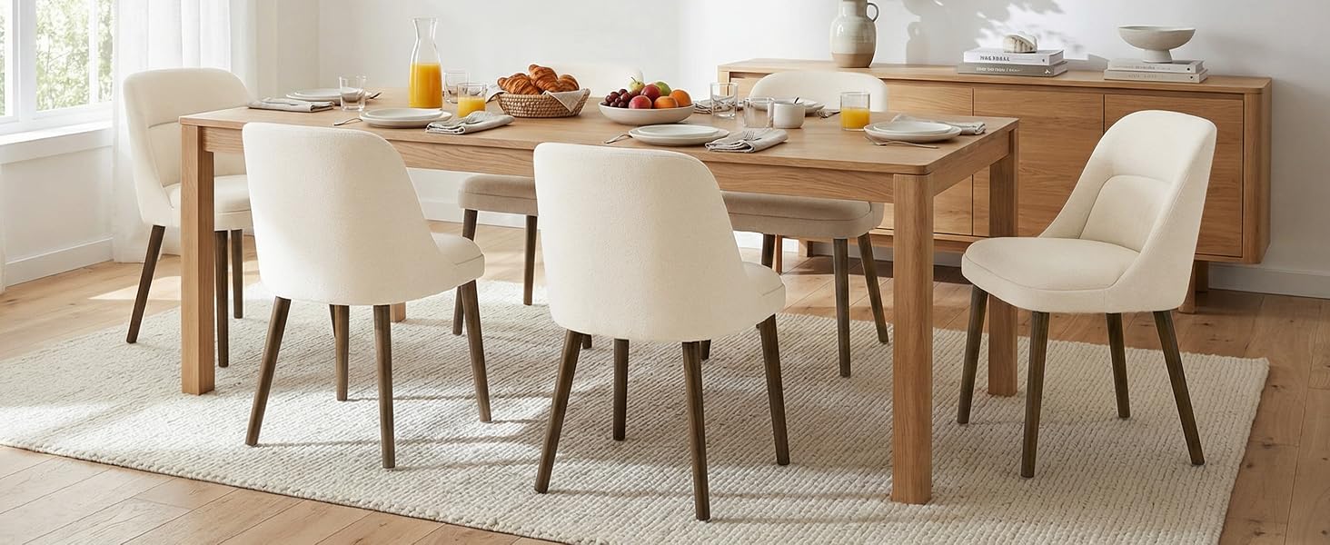 Dining room set featuring wooden table with cream-colored upholstered chairs in modern style setting.