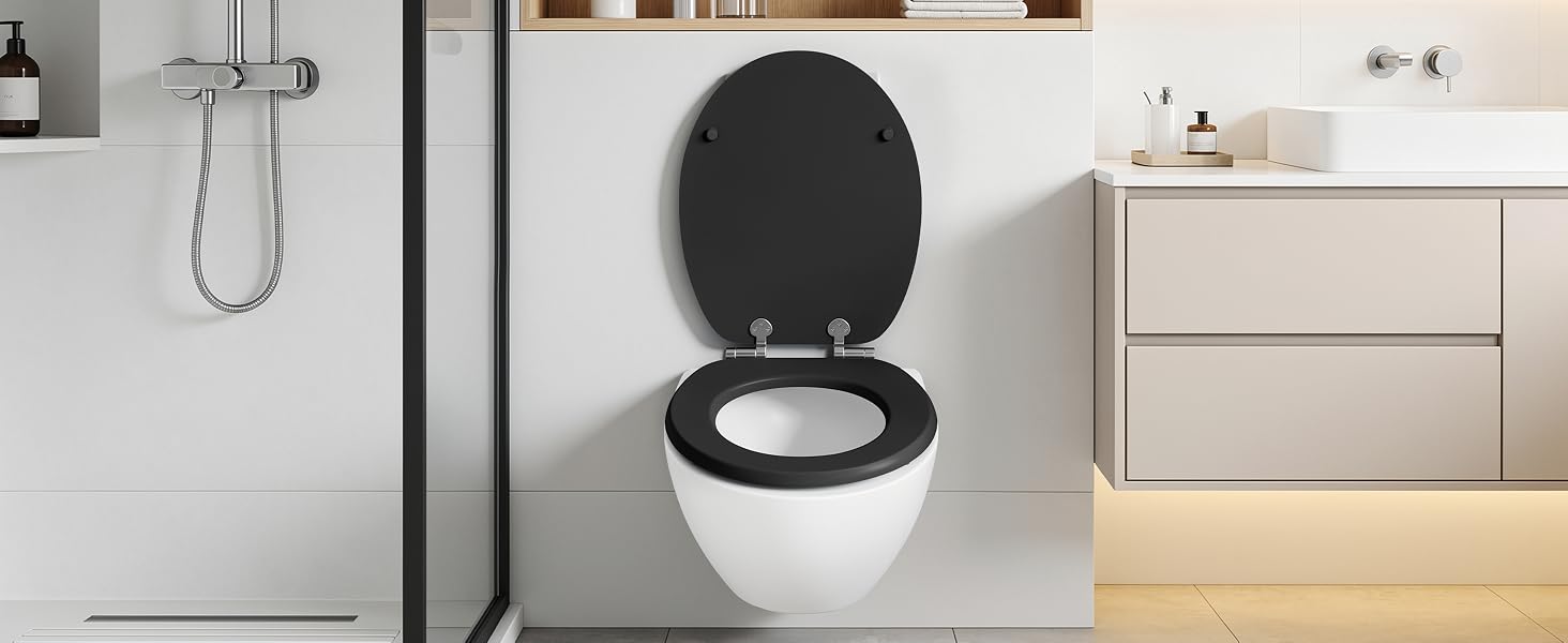Modern bathroom interior featuring black and white elongated toilet seat with lid open, sleek bathroom vanity, and contemporary chrome shower fixtures.