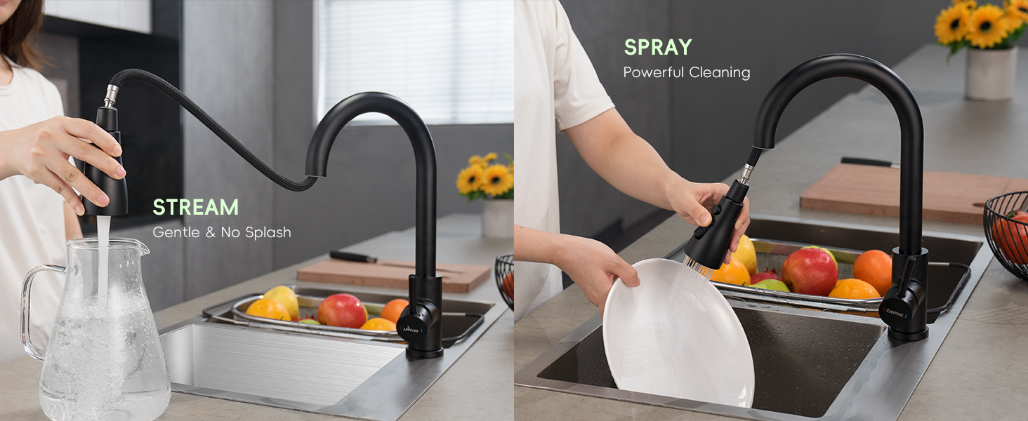 Black kitchen faucet with dual functionality showing stream and spray modes, mounted on stainless steel sink with fruits visible.