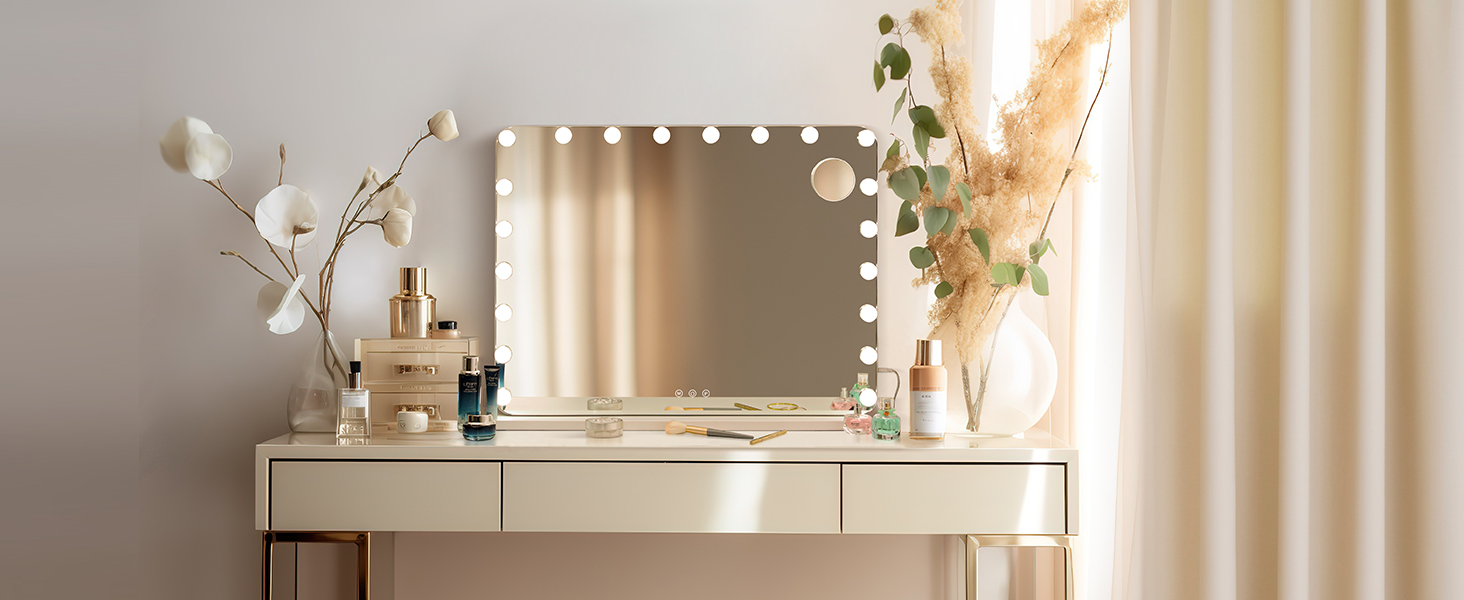 Vanity area with illuminated mirror, white furniture, and decorative elements including dried flowers against neutral-toned wall.