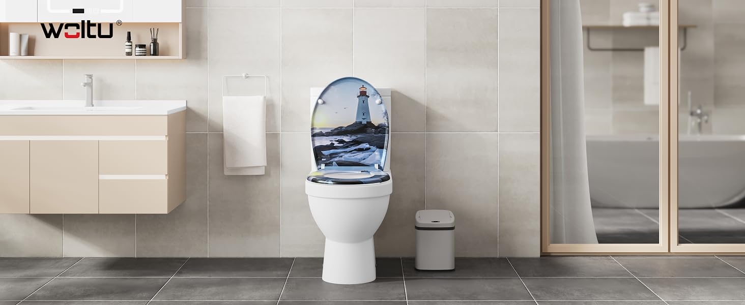 White porcelain toilet with a decorative blue and white lighthouse scene on the lid, set in a modern bathroom with beige tiled walls and wooden accents.