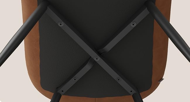Close-up detail of a black leather or vinyl chair seat with crossed strap design and metal rivet details at intersection points.