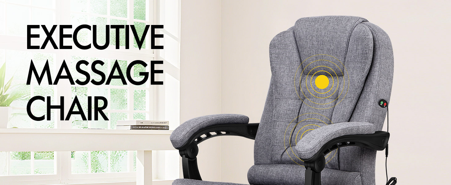 Text reads 'EXECUTIVE MASSAGE CHAIR'. Gray upholstered massage chair with black armrests and control panel, positioned in bright interior space with window background.