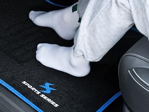 a child's feet on a car floor mat