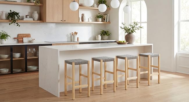 Modernes Kücheninterieur mit langer weißer Thekeninsel, Barhockern aus Holz und Pendelleuchten. Sauberes, minimalistisches Design mit natürlichen Holzakzenten.