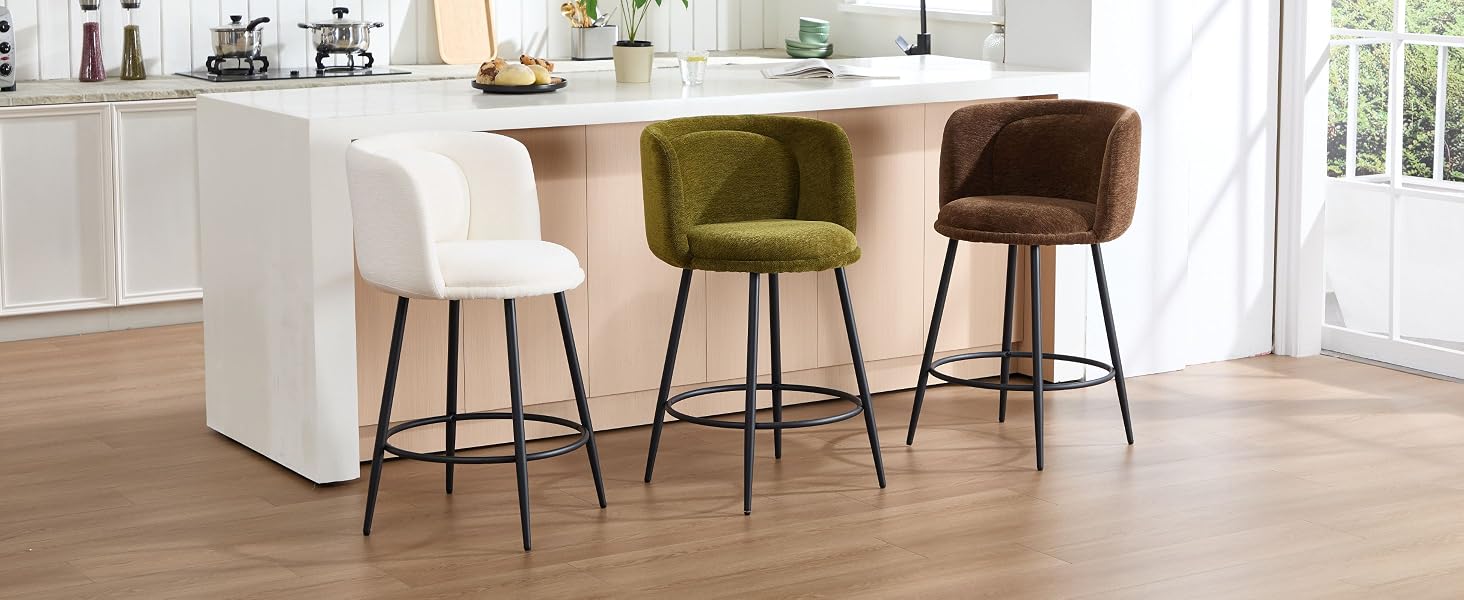Modern interior space with hardwood flooring and bar-height seating, featuring multiple upholstered stools in earth tones arranged along a white counter or bar area.