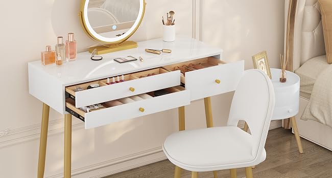 White vanity desk with gold accents, featuring two drawers and a circular LED mirror. Accompanied by a white chair with wooden legs.