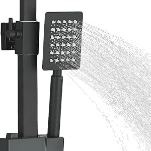 Black showerhead with square perforated face mounted on adjustable black pole, demonstrating water spray pattern flowing downward against white background.