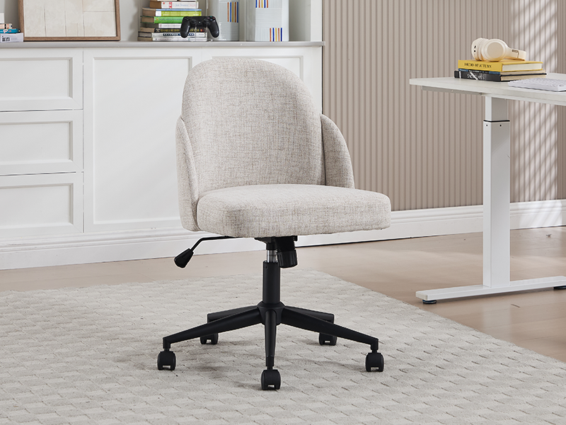 Cream-colored office chair with upholstered seat and backrest, mounted on wheeled base. Shown in modern home office setting with white desk.
