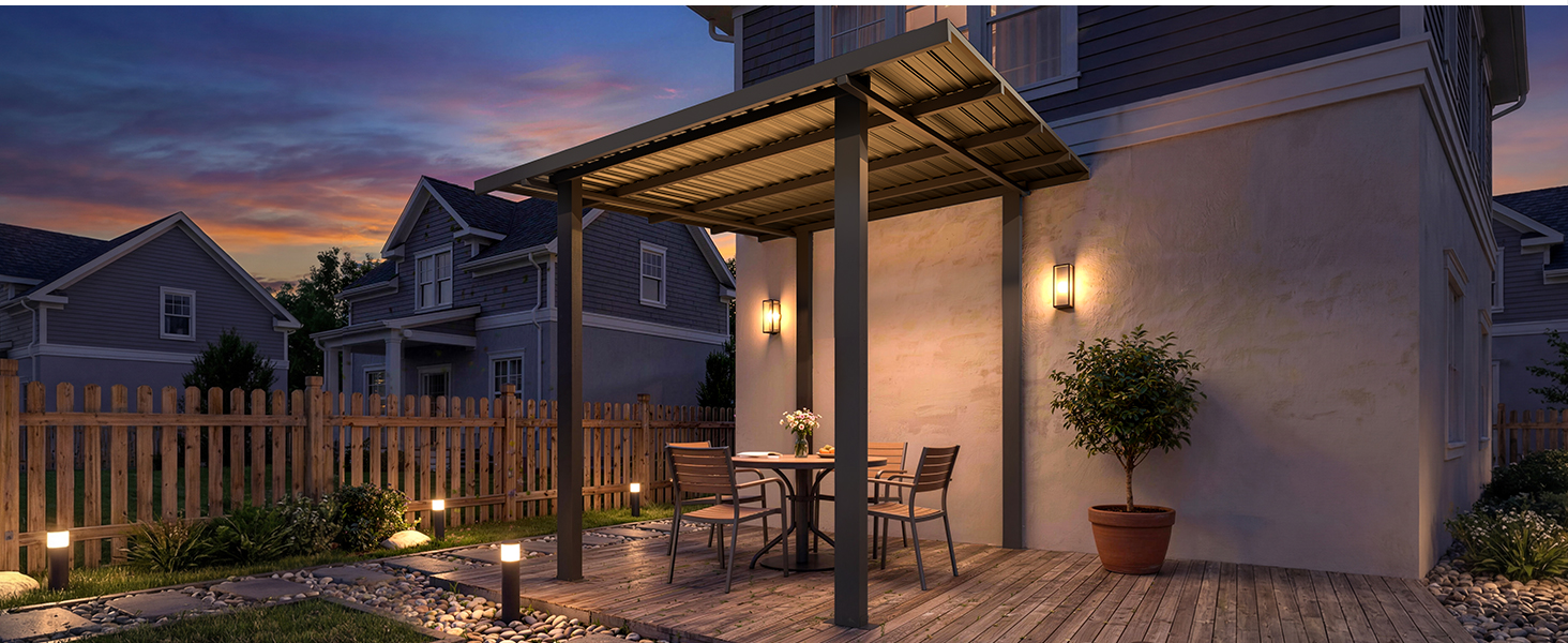 Outdoor patio at dusk showing covered pergola structure with lighting, comfortable seating, and decorative landscaping creating warm evening ambiance.