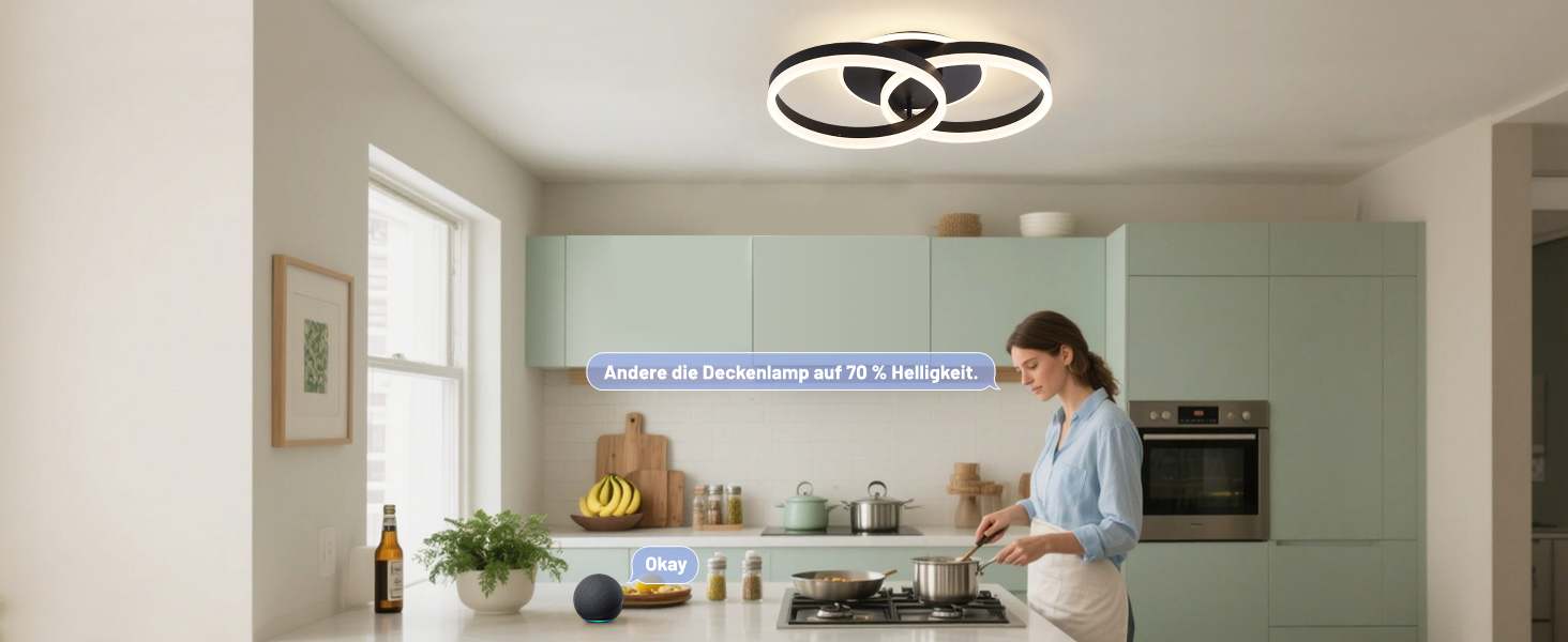 Modernes Kücheninterieur mit mintgrünen Wänden, Einbaugeräten und Deckenbeleuchtung. Jemand ist sichtbar, der an der Theke arbeitet.