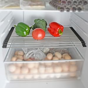 Un refrigerador con una rejilla de metal con verduras encima.