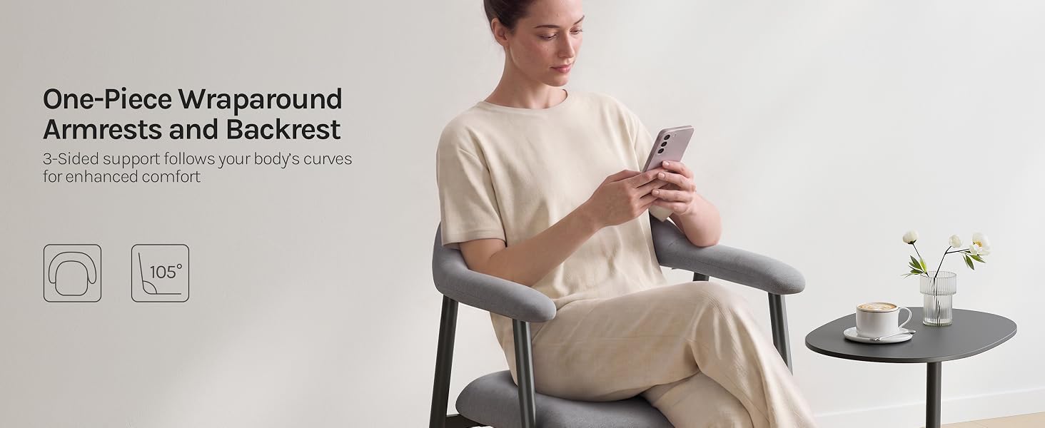 Text reads 'One-Piece Wraparound Armrests and Backrest.' Person in beige sweater sits in light upholstered chair next to small round side table with flower vase. Modern furniture piece with integrated design.