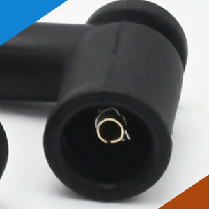 Close-up view of a black cylindrical device with a metallic connection port visible at one end.