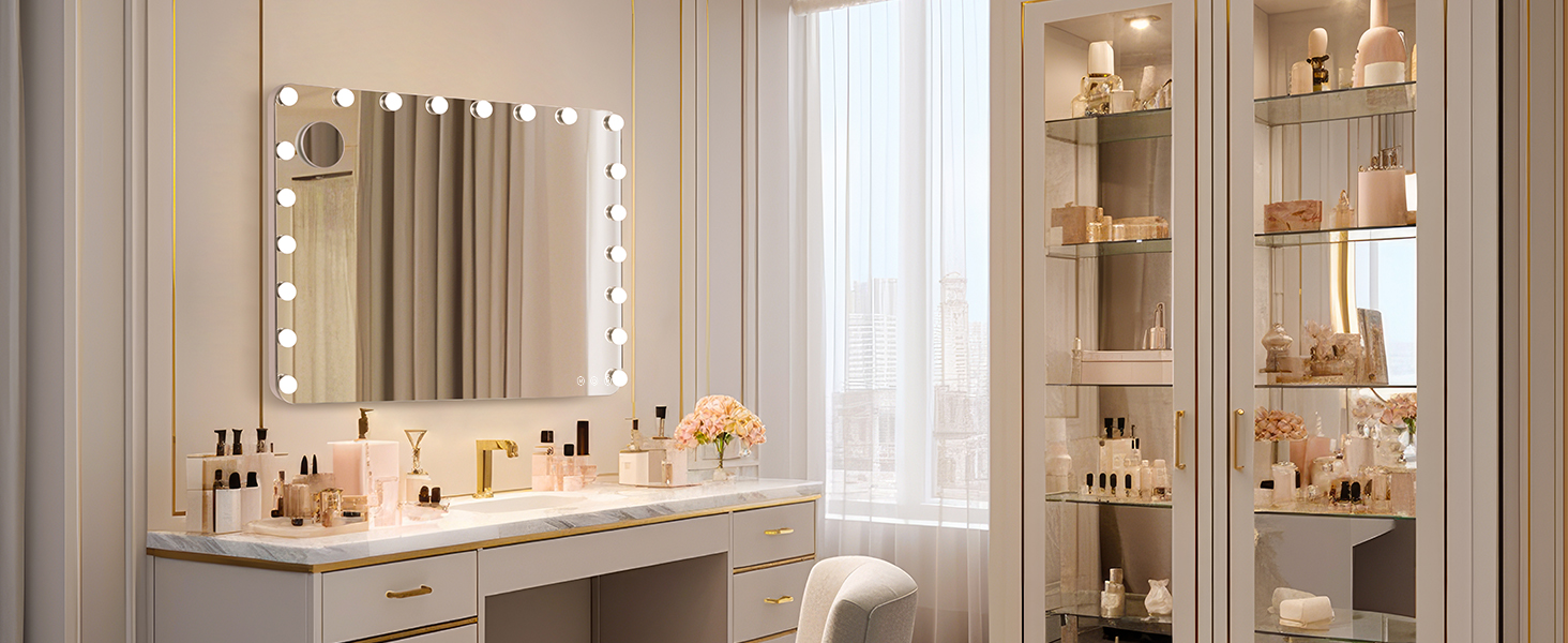 Elegant vanity setup with illuminated mirror, featuring organized beauty products on white counter and glass shelving units.