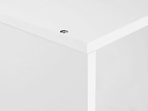 Close-up of a white table or surface corner, showing smooth edges and a flat top with a subtle sheen.