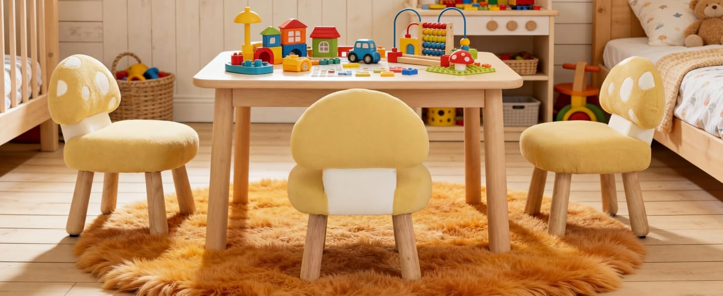 Children's play area featuring light wood table set with matching rounded chairs, colorful building blocks and toys displayed on tabletop.