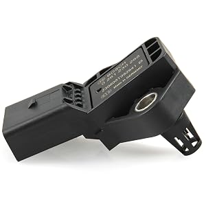 Black plastic electronic component with mounting brackets and ventilation slots, featuring a circular connector port on its angular body.