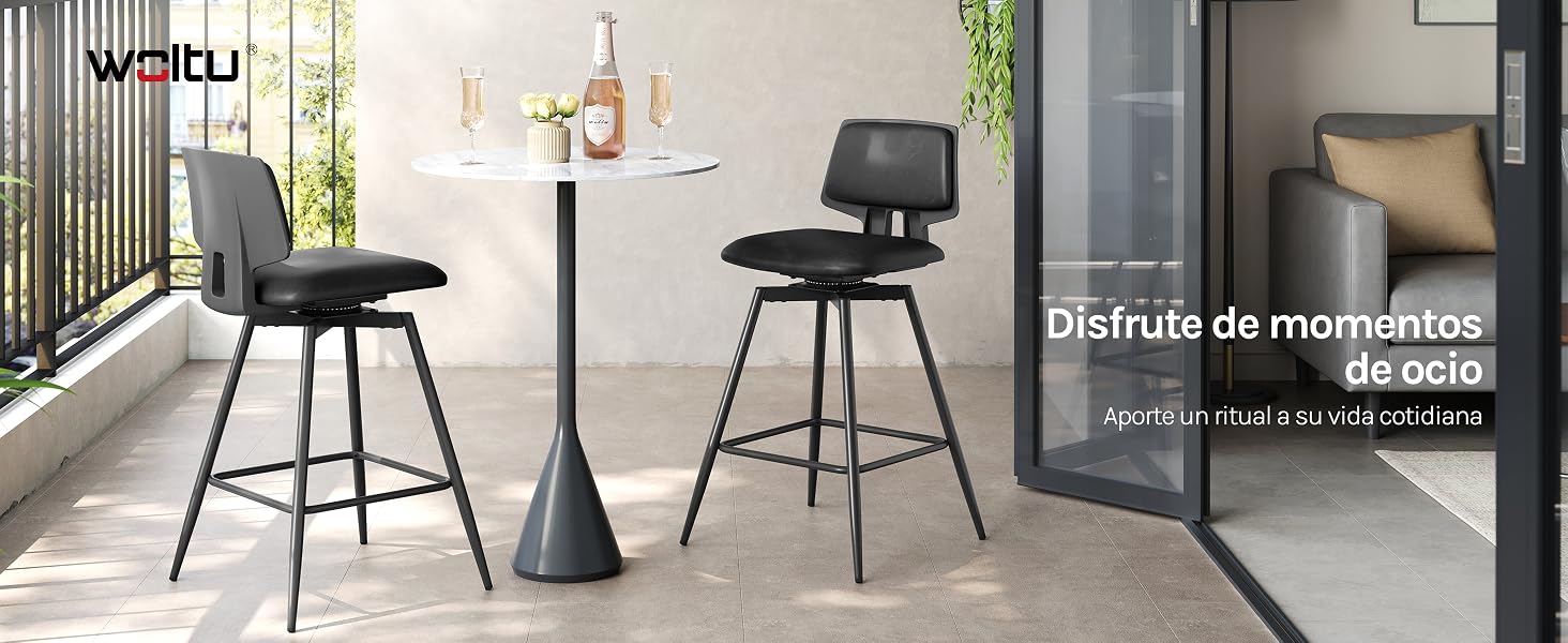 Dos taburetes de bar modernos negros con asientos curvos y bases de metal colocados junto a una mesa alta con pedestal en un patio o balcón al aire libre.