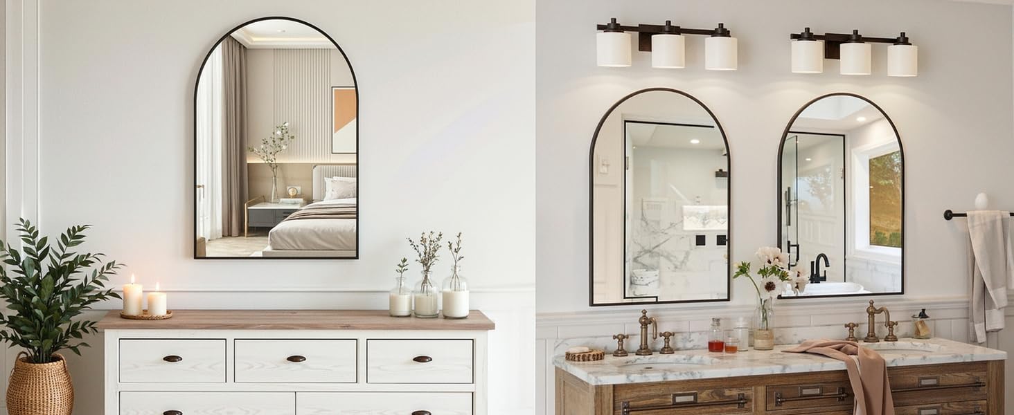 Modern bathroom interior with white vanity cabinets, wooden countertop, arched mirrors, wall sconces, and potted plant decoration.