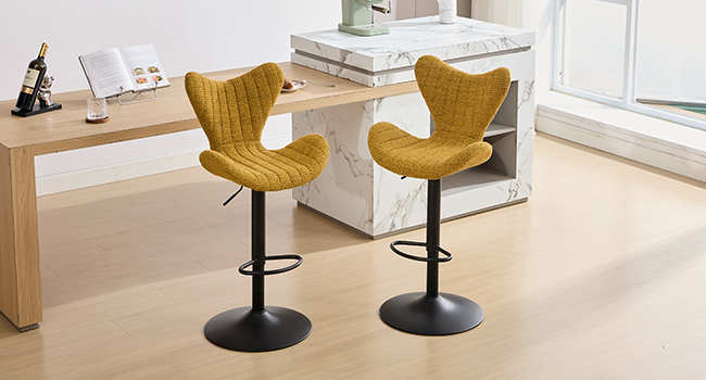 Modern office space featuring yellow leather bar stools with metal bases arranged around a light wooden counter or bar area.