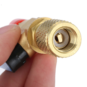 Close-up of a brass-colored connector with a threaded exterior and smooth interior, attached to a black cable.