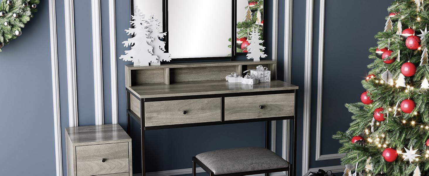 Wooden vanity with mirror, decorated for Christmas with tree, wreath, and hanging star ornaments