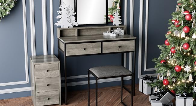 Wooden vanity with mirror, decorated for Christmas with tree, wreath, and hanging star ornaments