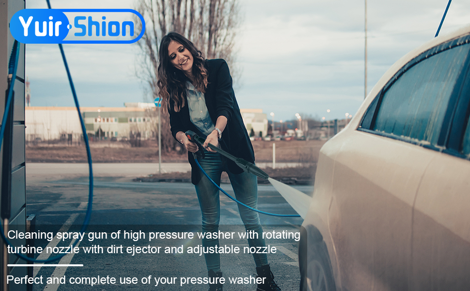 a woman is washing her car with a hose.