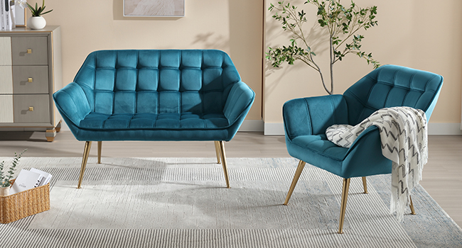 Teal velvet living room set: tufted sofa and armchair with gold metal legs. White throw blanket on armchair. Wooden side table visible.