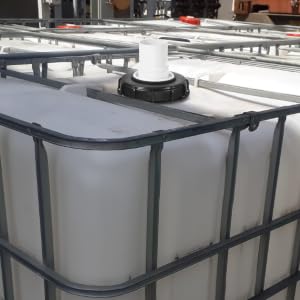 Multiple white cylindrical containers or tanks arranged in a row, secured within a metal frame or support structure.