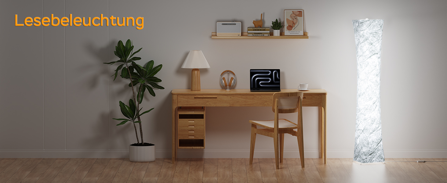 Home office setup with wooden desk, chair, and shelving. Decorative items include a table lamp, potted plant, and a tall cylindrical floor lamp emitting soft light.