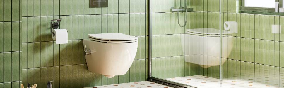 Interno bagno moderno con due wc a parete. Pareti e pavimento piastrellati verdi. Divisorio in vetro che separa