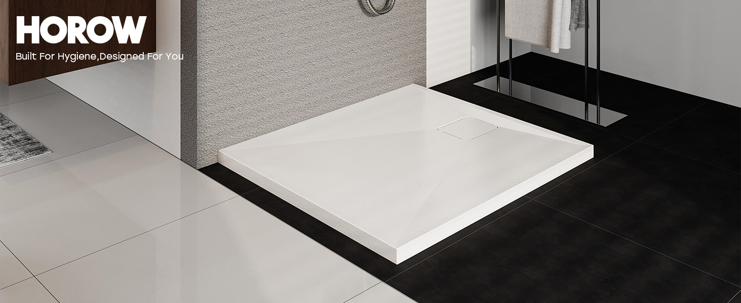 Text reads 'HOROW'. Modern minimalist bathroom interior with white porcelain fixtures, including wall-mounted toilet and clean tile surfaces.