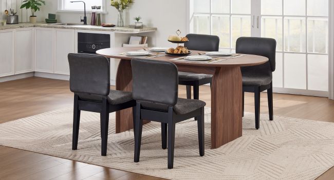 Moderne Essgruppe mit Holztisch mit schwarz gepolsterten Stühlen in einer modernen Kücheneinrichtung mit weiß gefliesten Wänden.