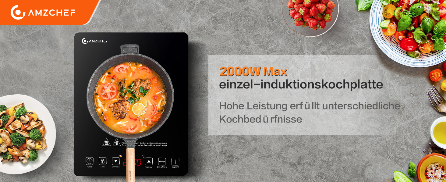 Tragbares Induktionskochfeld mit Orangensuppe im Topf. Das Display zeigt Temperaturregler an. 2000 W maximale Leistung. Umgeben von Zutaten wie Tomaten und Salat