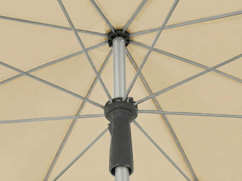 Close-up sequence showing mechanical components of an umbrella or parasol frame, focusing on the central hub and support structure against a beige background.