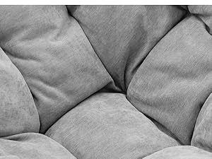 Detalle detallado de cojines tapizados grises o material de asiento que muestra la textura, el acolchado y el patrón de la superficie acolchada en tonos grises monocromáticos.